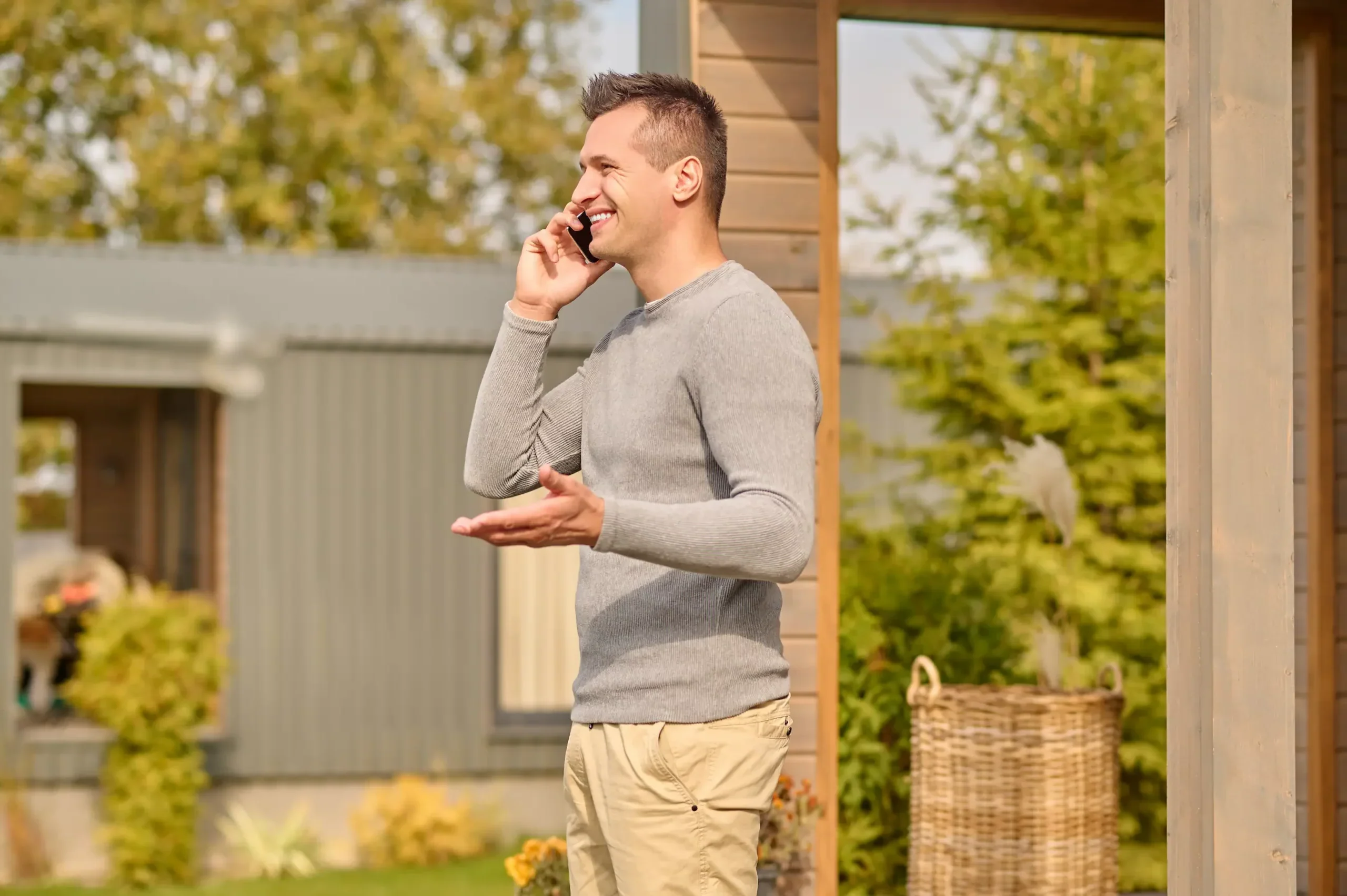 Side view of a man on a smartphone outdoors, representing someone researching the answer to What is a Self-Employed Mortgage